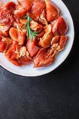 raw meat pork or beef in a plate on the table (preparing healthy food, marinade and spices paprika) menu concept background. top view. copy space
