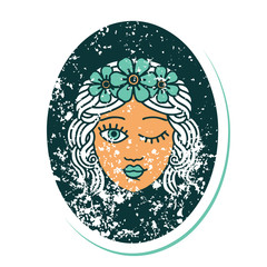 distressed sticker tattoo style icon of a maiden with crown of flowers winking