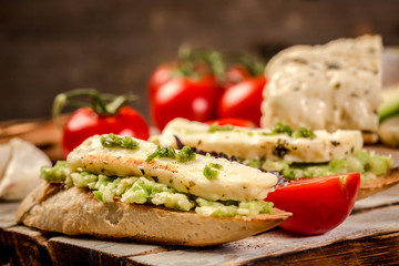 Delicious sandwiches and toasts. The concept of eco products. Vegetarian wholesome food. Parmesan, feta, goat cheese. Background image. Copy space