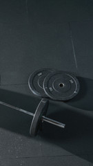 Two barber plates A set of heavy barbells on a gym floor Fitness equipment for workout in Gym....
