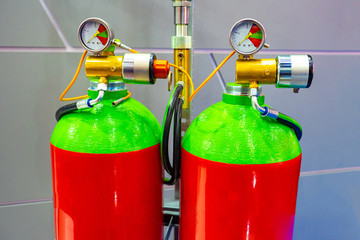 Gas equipment for industrial purposes. Two red-and-green gas tank. Cylinders are equipped with pressure gauges. Gas welding. System of two cylinders.