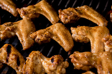 Fried chiken wings at grill barbecue. Restaurant.