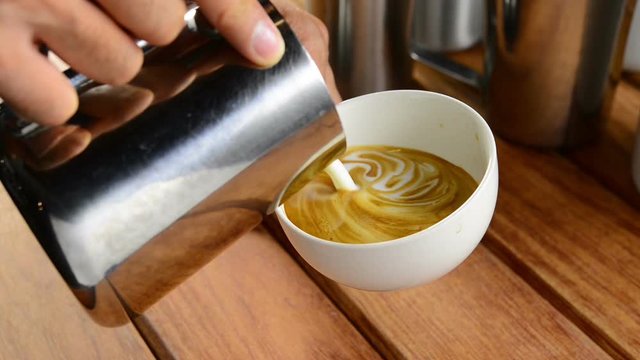 Barista making coffee , Making latte art coffee .