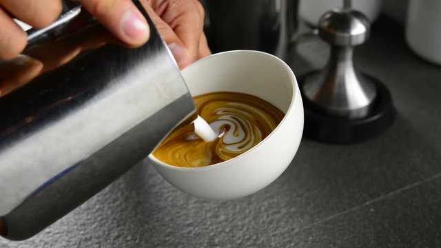 Barista making coffee , Making latte art coffee .