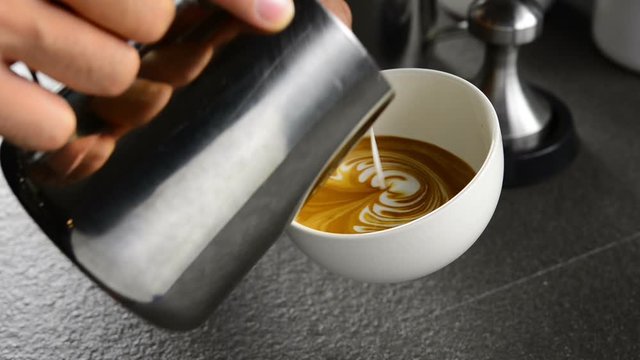 Barista making coffee , Making latte art coffee .