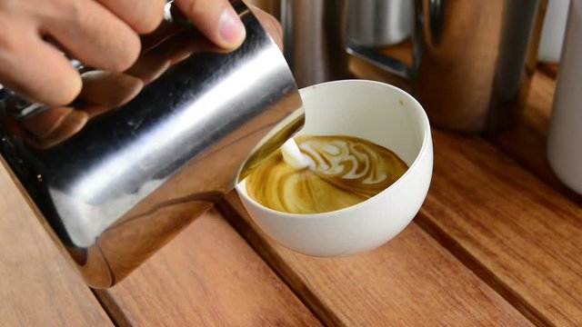 Barista making coffee , Making latte art coffee .