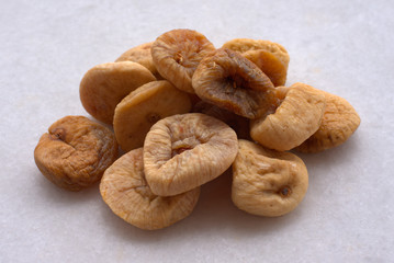 Dried figs  chocolates, peanuts  and apricots on white background