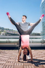 Handstand on rooftop with personal trainer.
