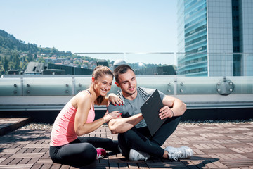 Personal trainer sitting with his client