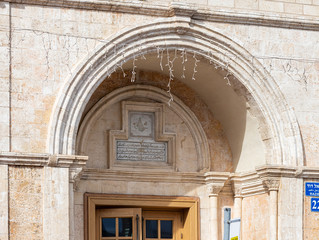 The old building with suras from the Koran above the entrance in old Yafo in Israel