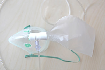 isolated oxygen medical mask for asthma or emergency patients at hospital on clean wooden table
