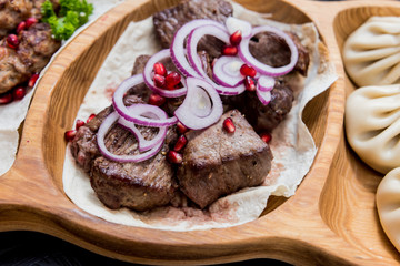 Georgian cuisine food. Grilled meat with khinkali. Georgian restaurant.
