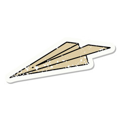 traditional distressed sticker tattoo of a paper aeroplane