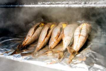 Large barbecue smoker grill at the park. Meat prepared in barbecue smoker.