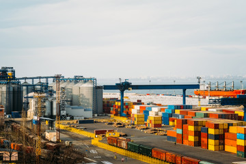 Obraz premium Black Sea trade port, containers loading by crane. International marine shipping. Container import export logistic, cargo harbor view, water transport. Industrial freight. Seaport cranes panorama.