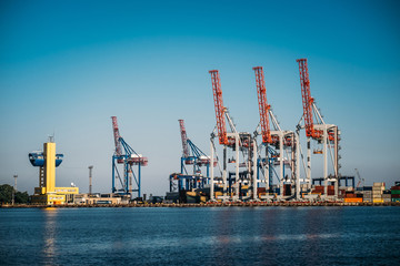 Obraz premium Black Sea trade port, containers loading by crane. International marine shipping. Container import export logistic, cargo harbor view, water transport. Industrial freight. Seaport cranes panorama.