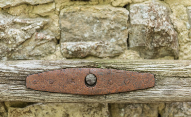 Weathered farmers tool on stone wall