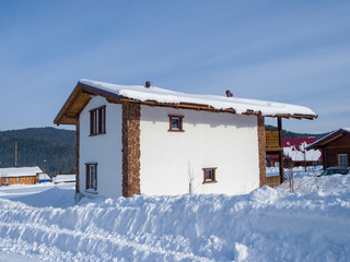 Wooden two-story Alpine-style house. Hotel in the ski resort Gornaya Salanga. Winter day