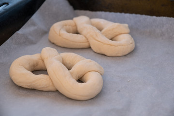 homemade pretzel preparation on white table