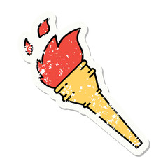 traditional distressed sticker tattoo of a lit torch