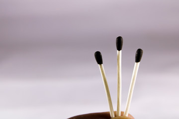 A creative concept of a wax match box with with stick and black head 