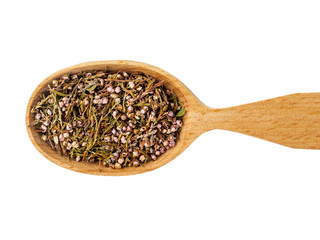 Dry Calluna vulgaris or Heather in wooden spoon on white background