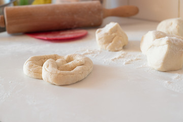 homemade pretzel preparation on white table