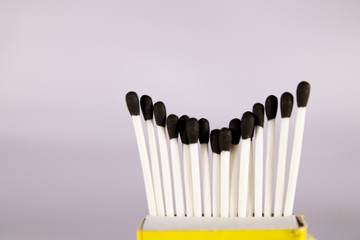 A creative concept of a wax match box with with stick and black head 