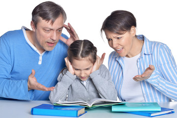 Fototapeta na wymiar Angry parents screaming on daughter who doing homework