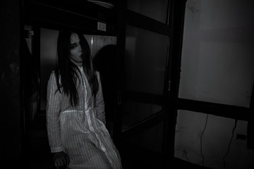 Portrait of asian woman make up ghost face with blood,Horror scene,Scary background,Halloween poster,Thailand people,Ghost movies poster