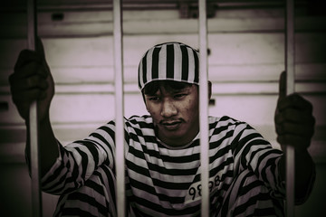 Portrait of man desperate to catch the iron prison,prisoner concept,thailand people,Hope to be...