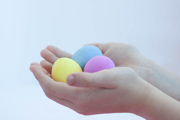 Hands holding multicolored eggs painted for the Easter holiday selective focus