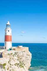 Fototapeta na wymiar lighthouse on the seashore as a navigator for ships