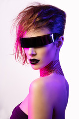 Colorful portrait of a young woman wearing futuristic glasses