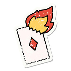 traditional distressed sticker tattoo of a flaming card