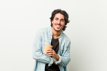 Young cool man drinking a coffee laughing and having fun.