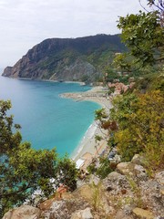 Fototapeta premium Italy, Cinque Terre, Monterosso Al Mare. Beautiful view of a coast line with greenery, turquoise sea and rocks