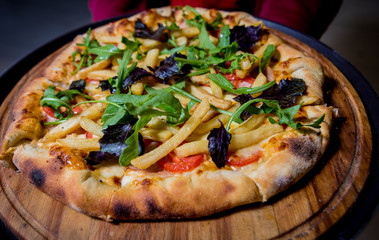 Tasty pizza with chicken and vegetables. Restaurant.