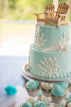 Coastal themed wedding cake and cupcakes