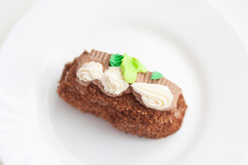 A piece of cake with colored cream in the dusting