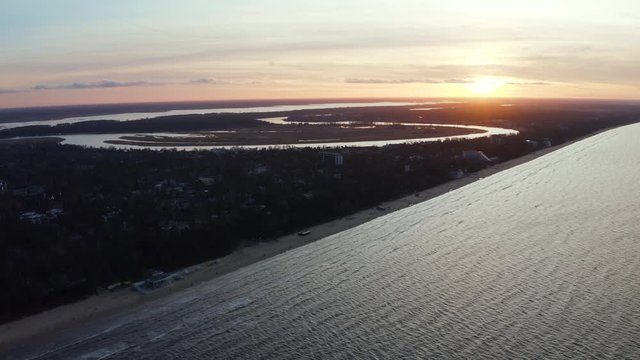 Beautiful epic purple sunset in Jurmala city, Latvia. Magical beach sunset by the Baltic sea. Aerial view.