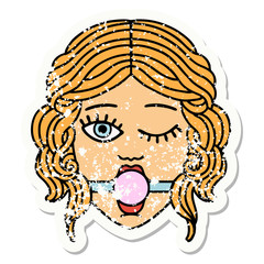 traditional distressed sticker tattoo of winking female face with ball gag