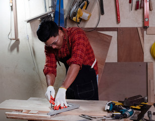 Handsome man doing wood work at factory,Handmade design,The carpenter