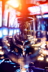 Wine and martini glasses in shelf above a bar rack in restaurant. 