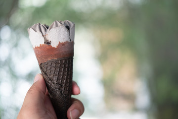 Man hand holding ice cream chocolate wafer cone