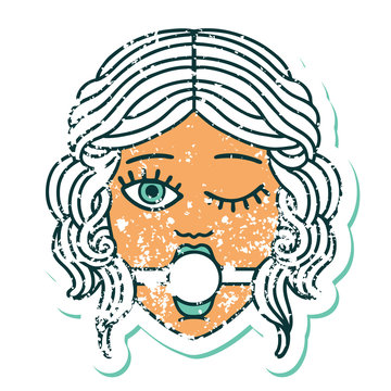 distressed sticker tattoo style icon of winking female face with ball gag