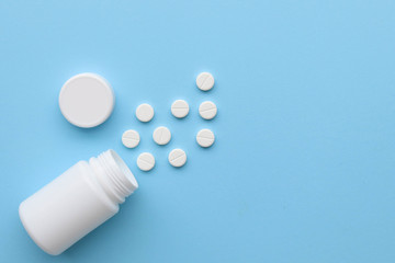 White tablets on a blue background, space for text