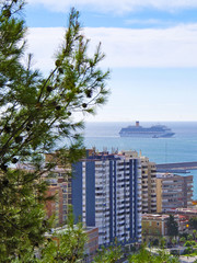 Modern Italian cruiseship or cruise ship liner in port of Malaga in Spain with panoramic and...
