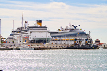 Modern Italian cruiseship or cruise ship liner in port of Malaga in Spain with panoramic and...