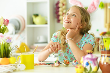 Obraz na płótnie Canvas Little beautiful girl is preparing for Easter